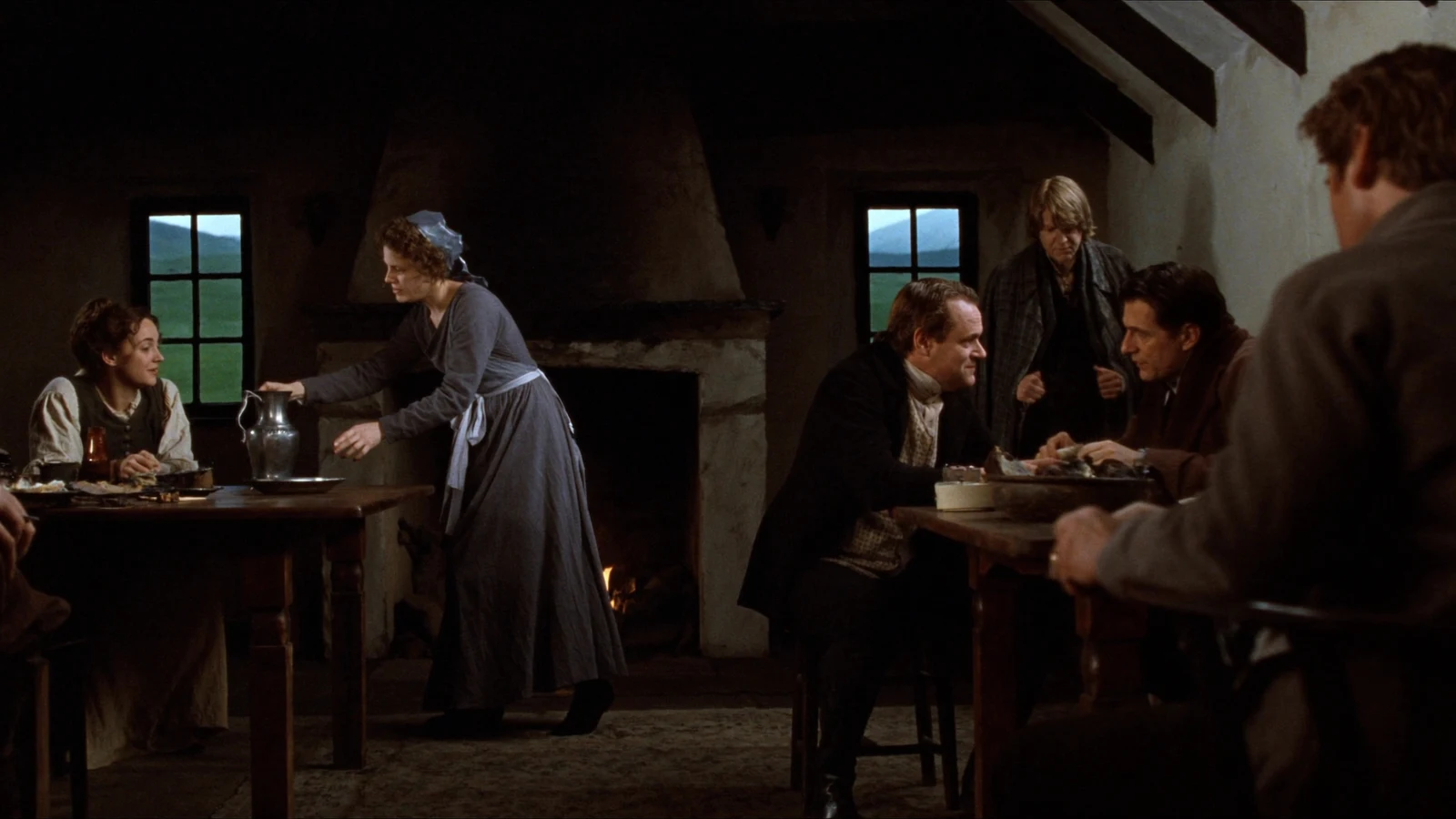 Villagers share supper in a firelit Scottish inn