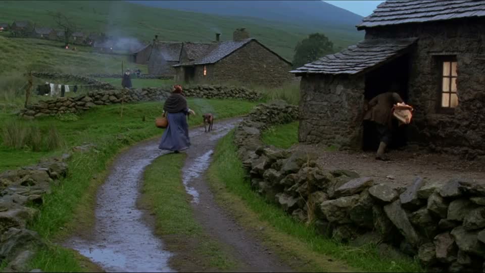 Villagers on a winding lane between Scottish stone cottages